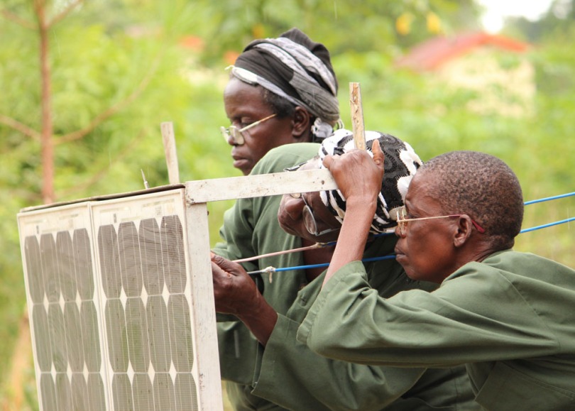 Women fixing a solar panel 